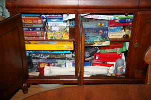 Many Board Games Taking Up a Cabinet